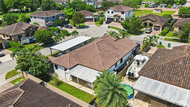 an aerial view of multiple houses with a yard