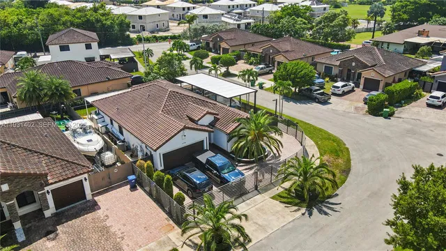 an aerial view of multiple houses with yard