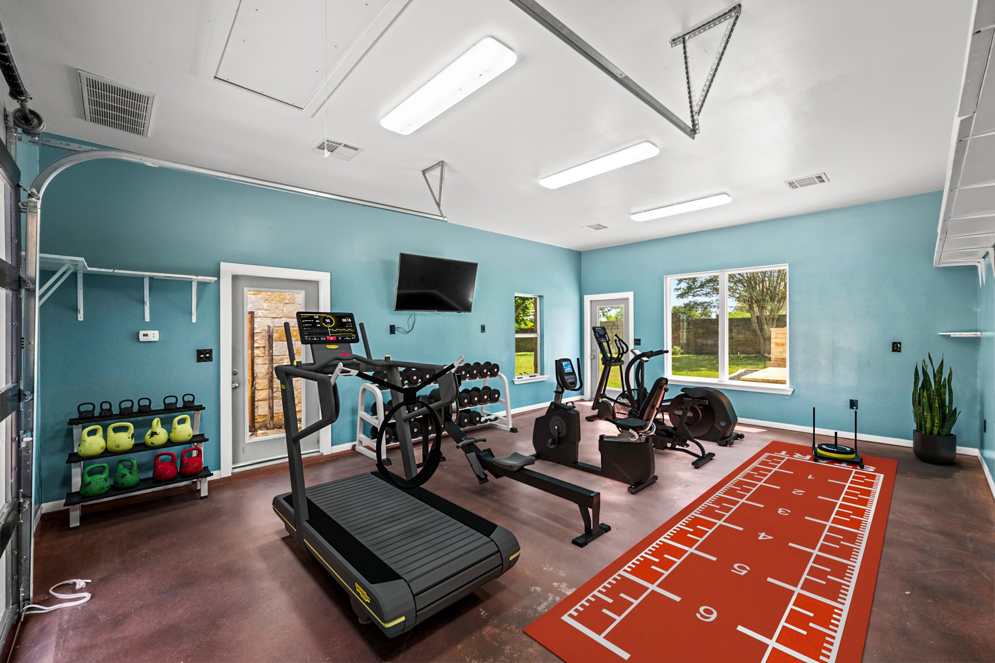 1023 Grassy Field Road Austin, TX 78737 - Photo 4 of 40 Detached 480 sq ft fully finished and climate controlled garage featuring a stained concrete floor, a large picture window and multiple access points. Endless opportunities here! Home gym, private office, workshop, or potential guest suite.
