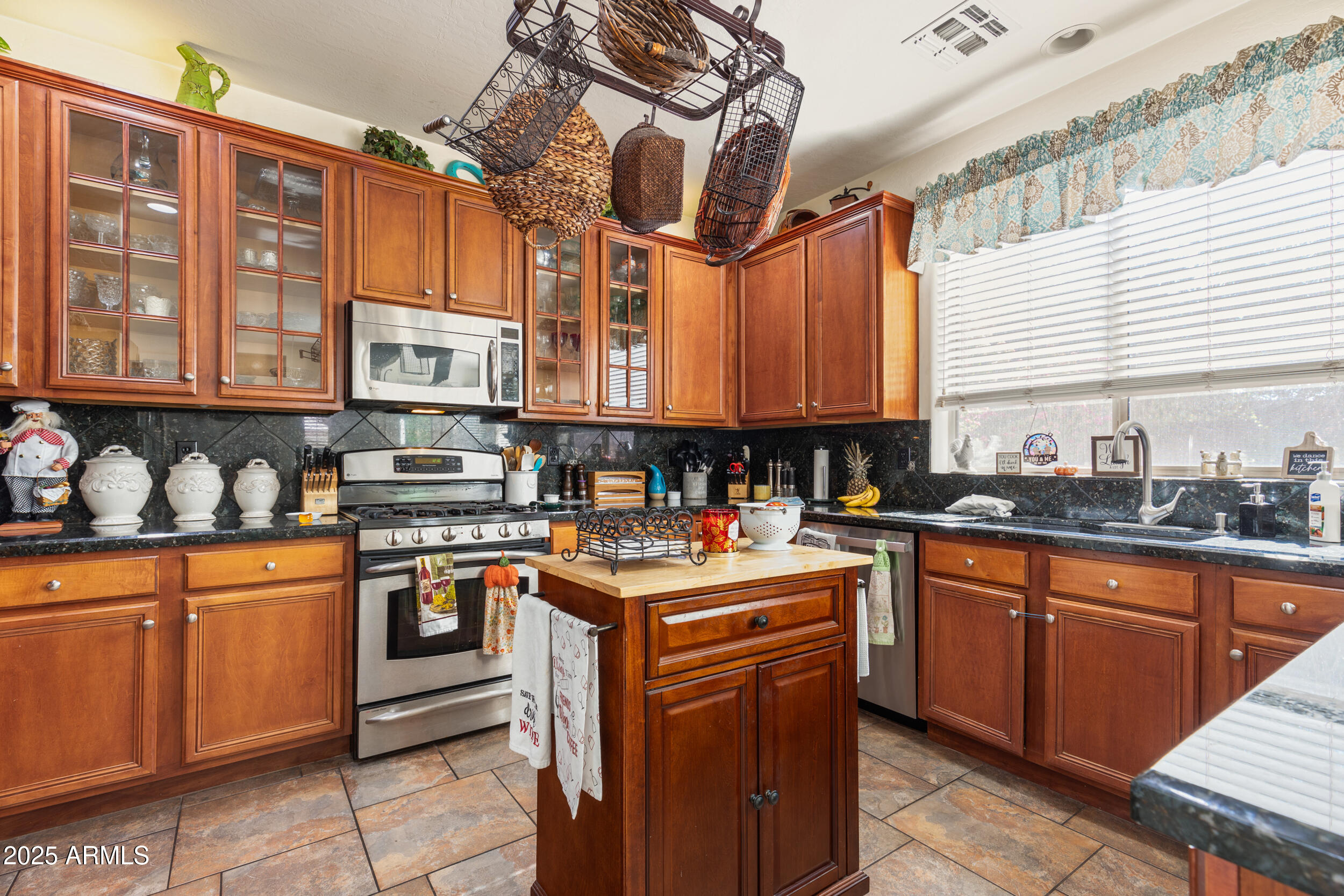 2821 East Nunneley Road Gilbert, AZ 85296 - Photo 14 of 51 a kitchen with stainless steel appliances granite countertop a sink and cabinets