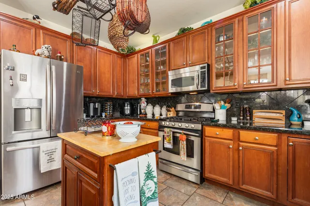 a kitchen with stainless steel appliances granite countertop a sink and cabinets