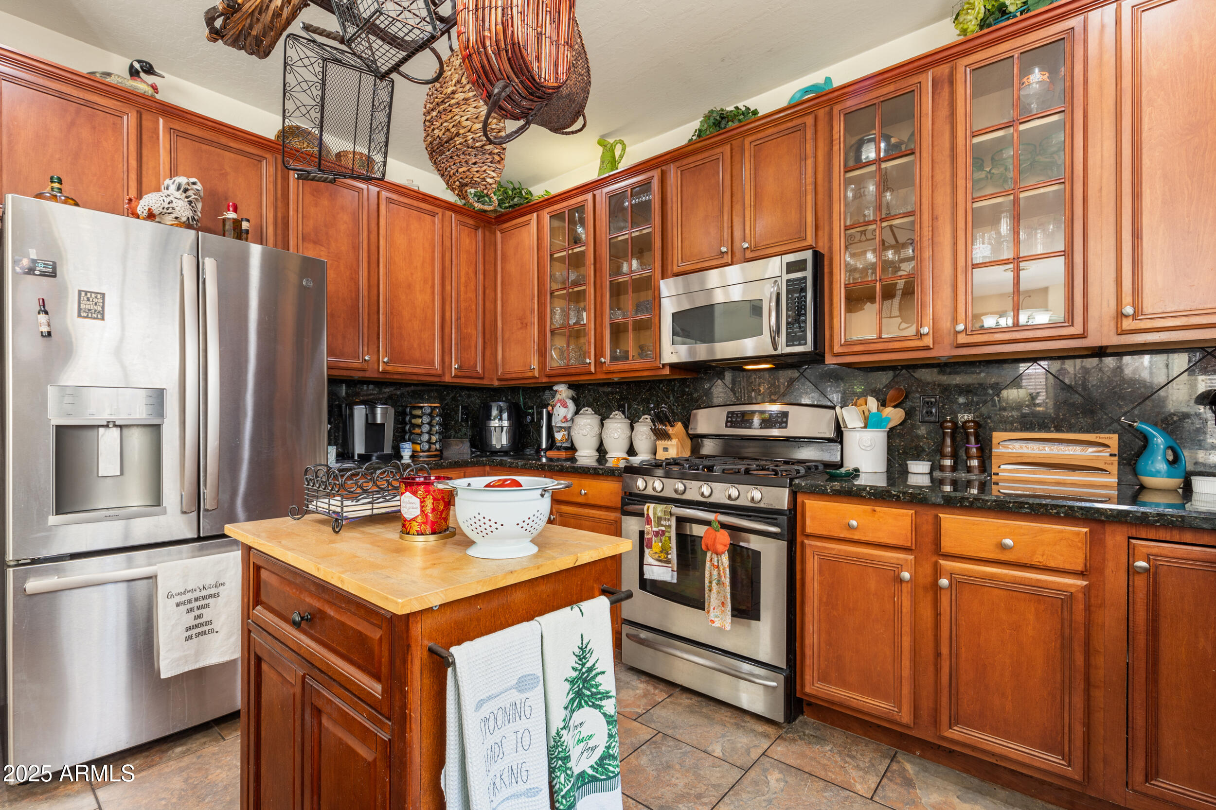 2821 East Nunneley Road Gilbert, AZ 85296 - Photo 16 of 51 a kitchen with stainless steel appliances granite countertop a sink and cabinets