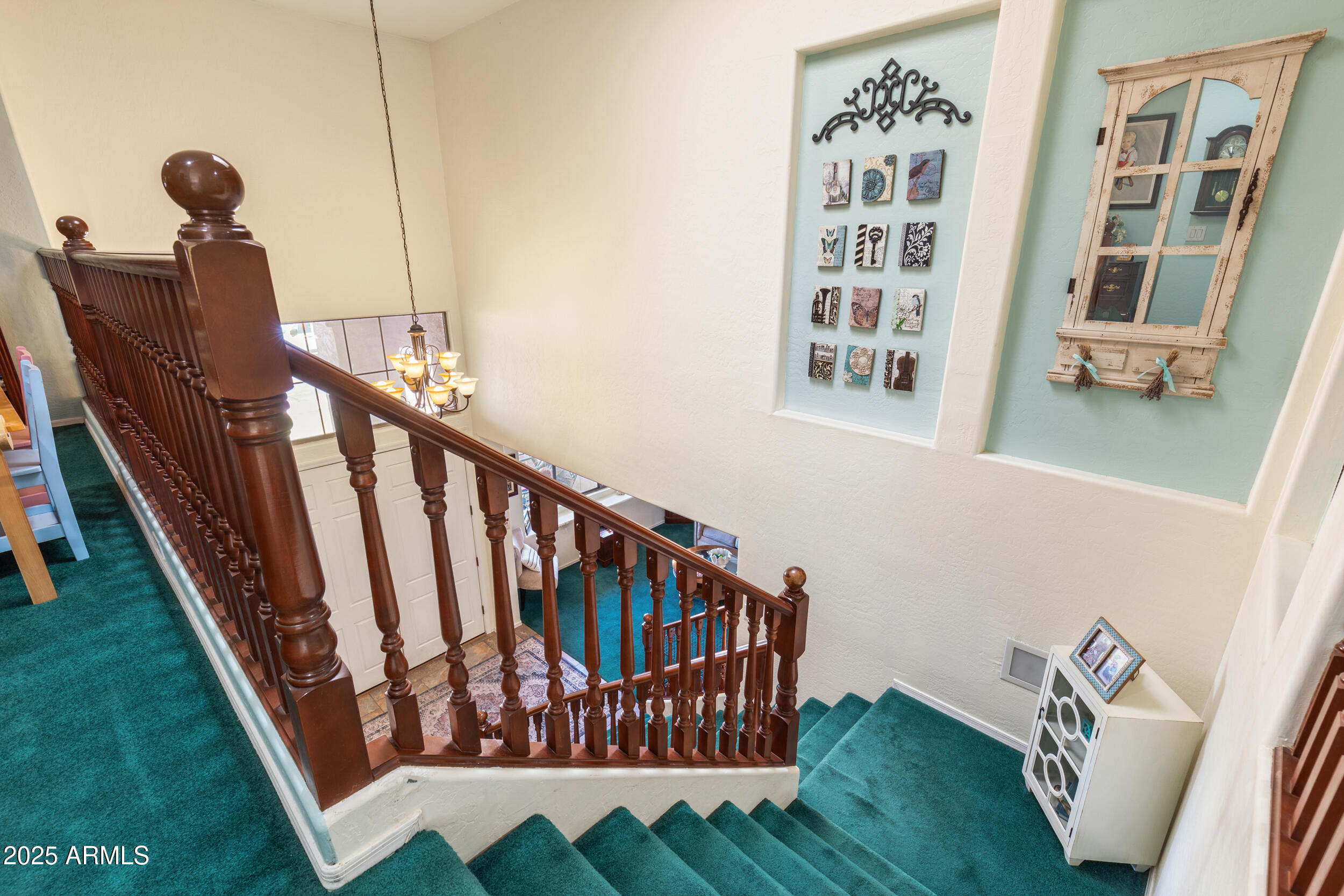 2821 East Nunneley Road Gilbert, AZ 85296 - Photo 25 of 51 a view of staircase with lots of frames on wall and a window