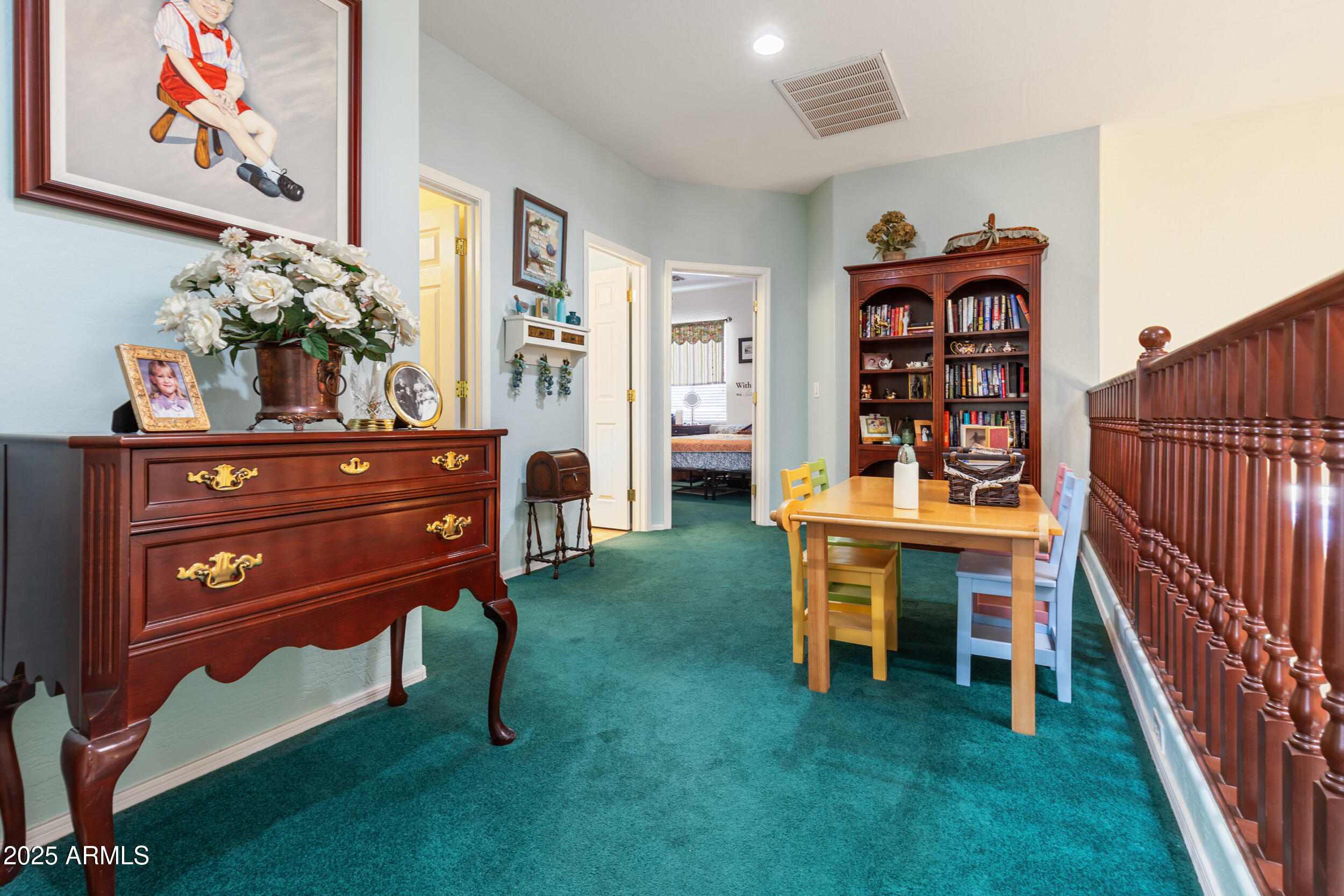 2821 East Nunneley Road Gilbert, AZ 85296 - Photo 26 of 51 a living room with furniture and a bookshelf
