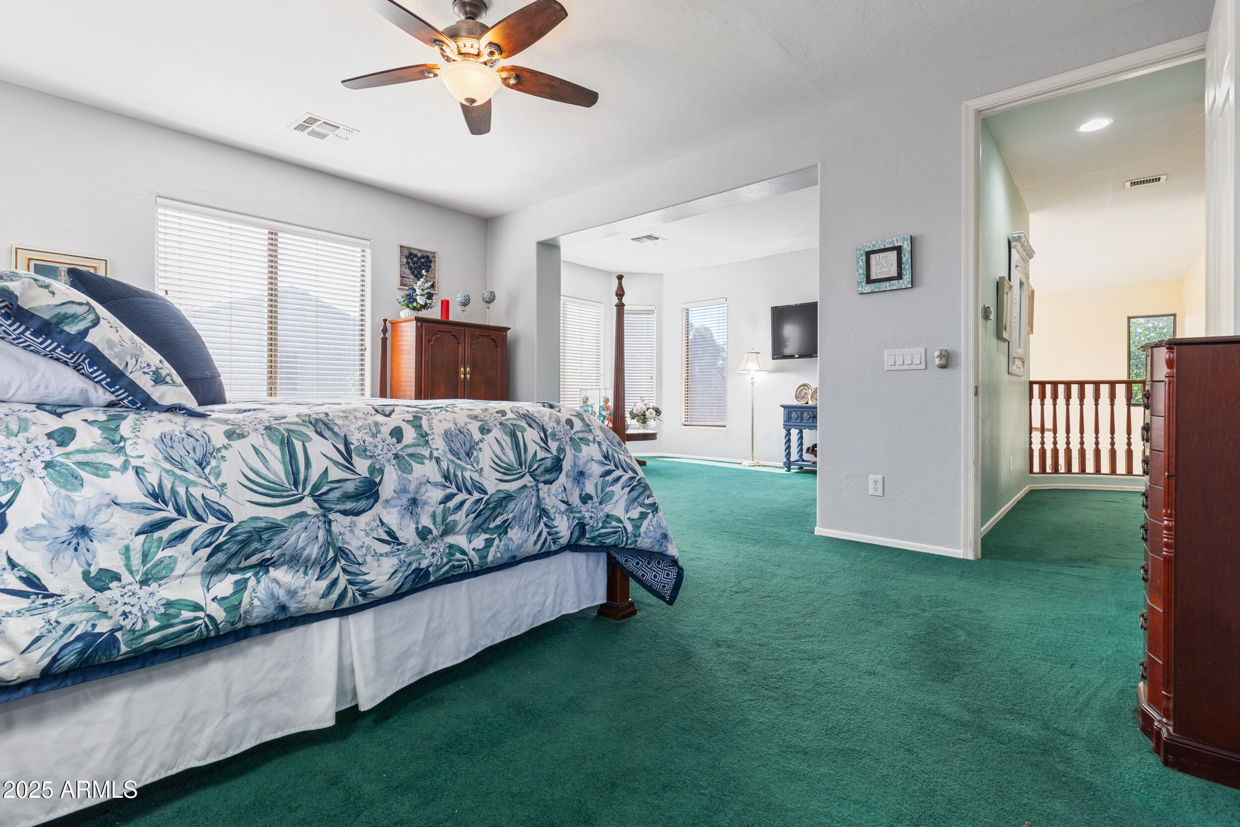2821 East Nunneley Road Gilbert, AZ 85296 - Photo 33 of 51 a spacious bedroom with a bed and a chandelier