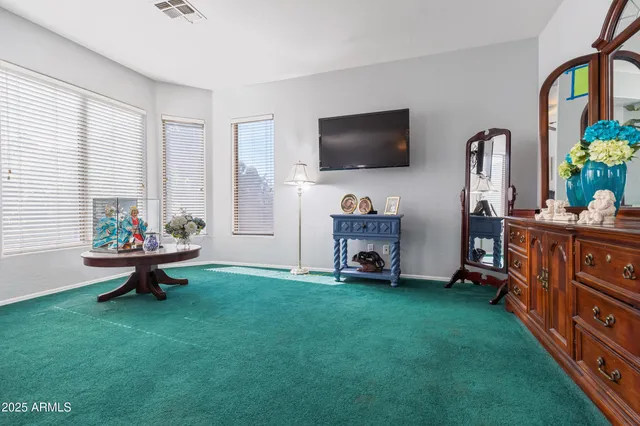 a bed room with a bed and a ceiling fan