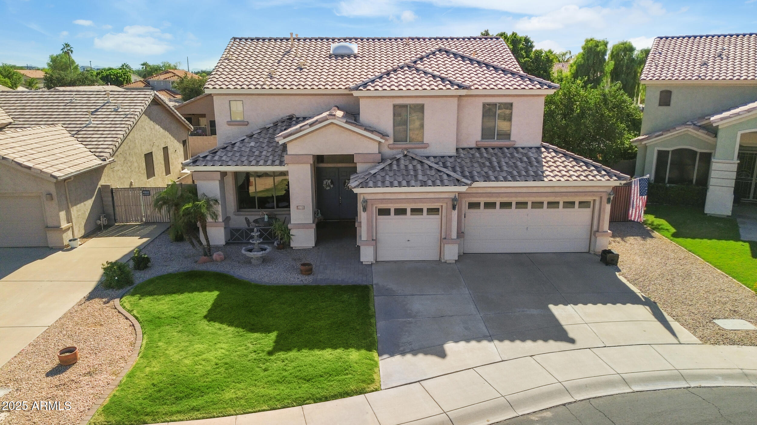 2821 East Nunneley Road Gilbert, AZ 85296 - Photo 44 of 51 a view of a white house with a yard