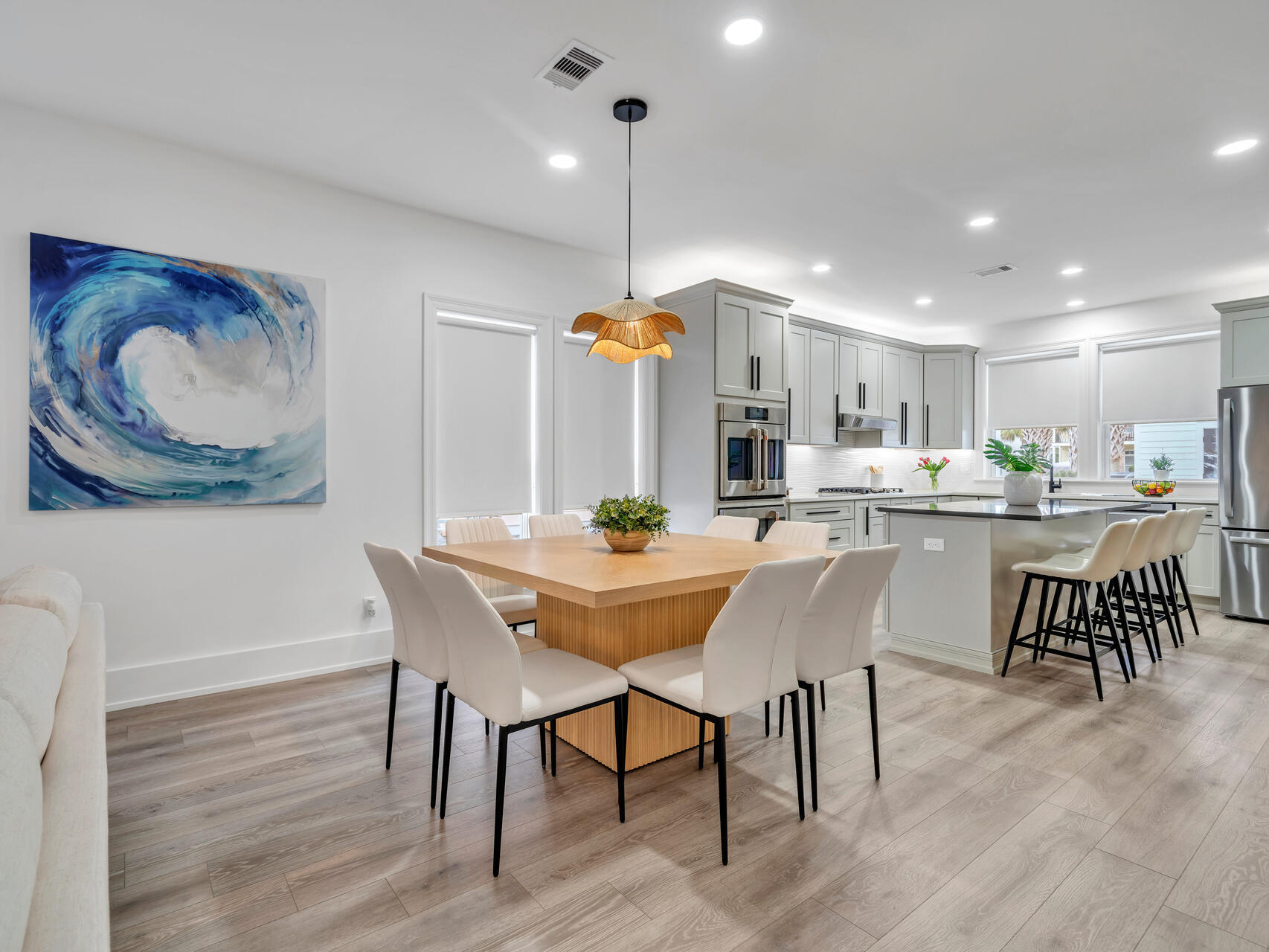 84 Mark Street Destin, FL 32541 - Photo 22 of 81 a dining room with stainless steel appliances kitchen island granite countertop a table chairs and a refrigerator