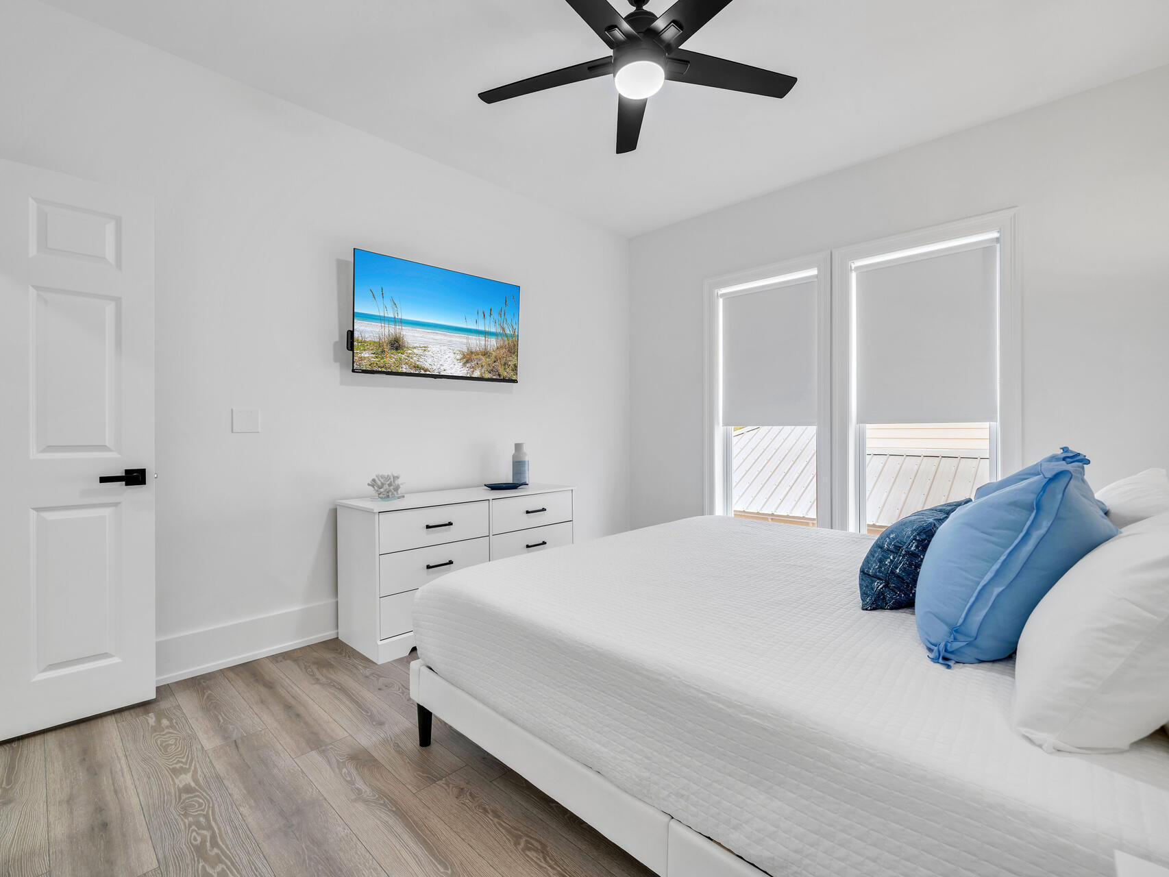84 Mark Street Destin, FL 32541 - Photo 37 of 81 a bedroom with a bed and a flat screen tv