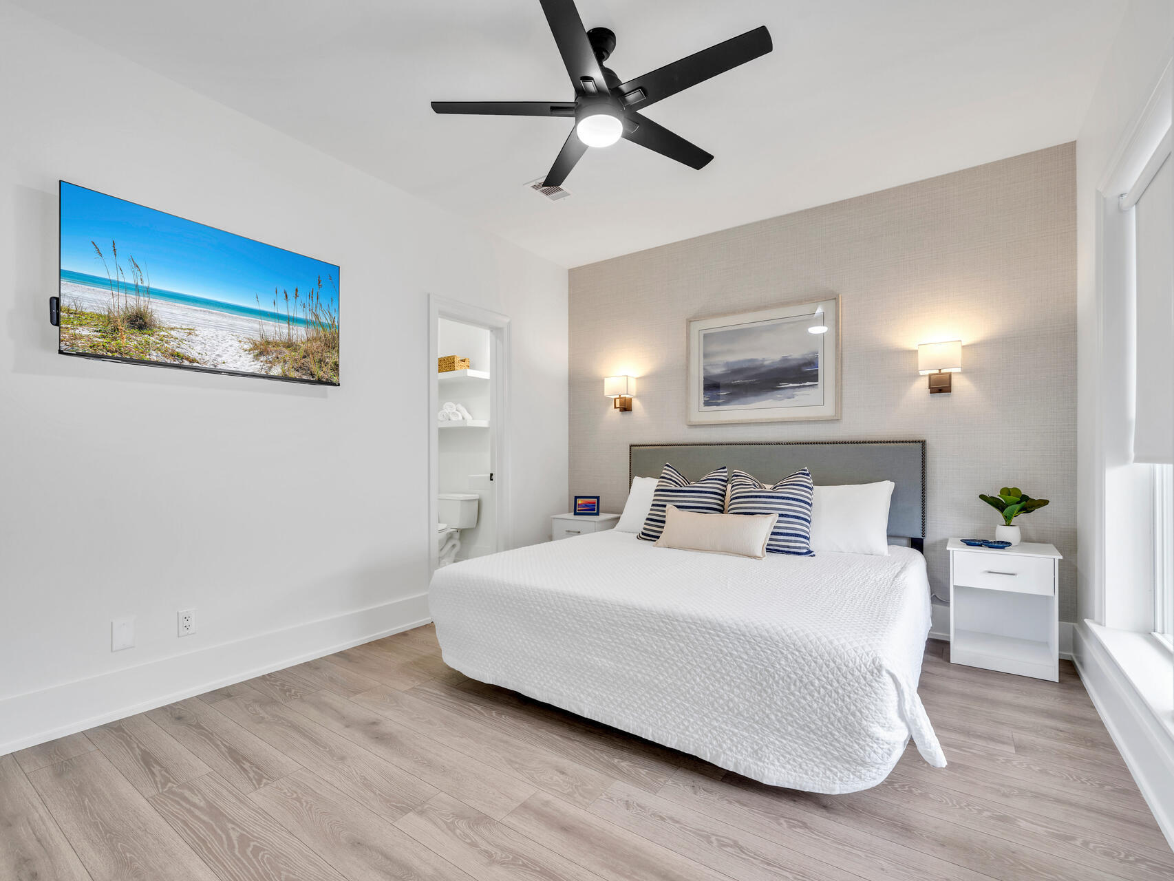 84 Mark Street Destin, FL 32541 - Photo 42 of 81 a bedroom with a large bed and a ceiling fan