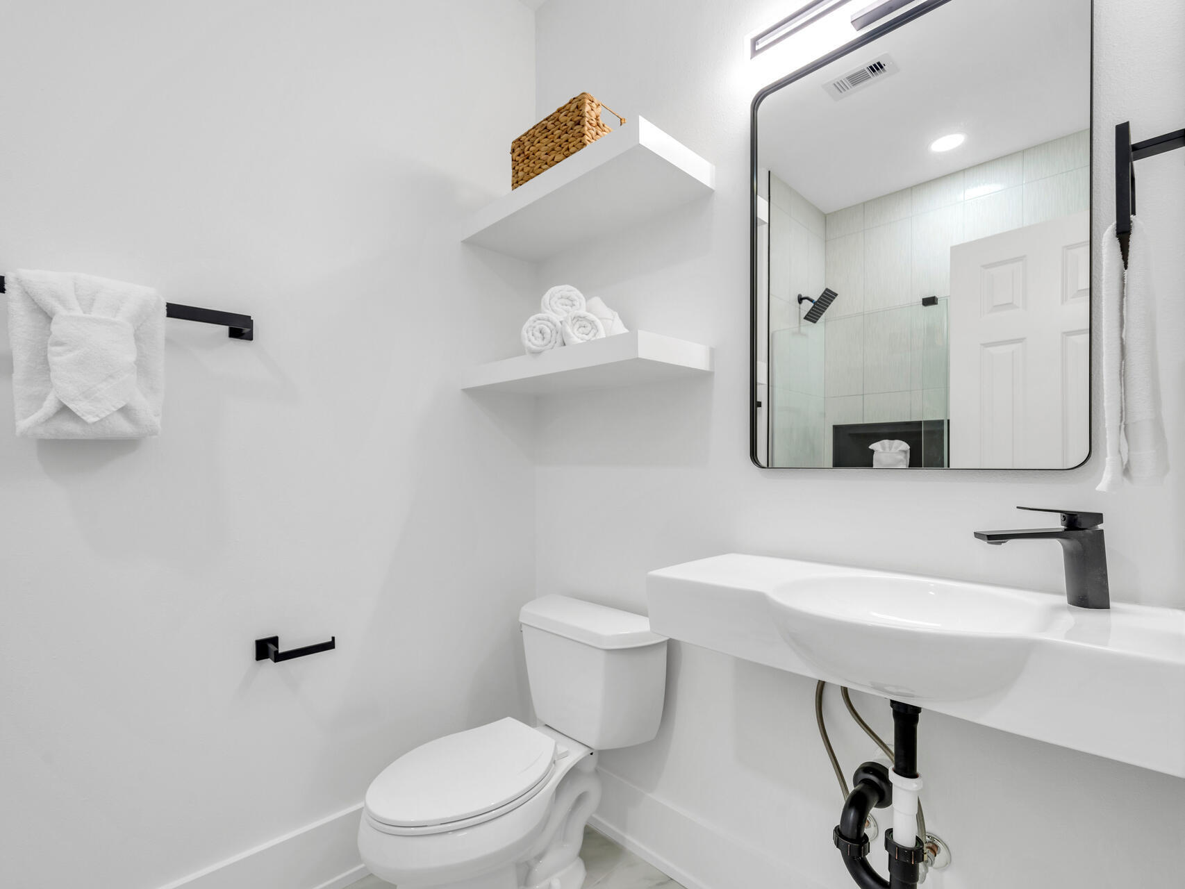 84 Mark Street Destin, FL 32541 - Photo 43 of 81 a bathroom with a sink a toilet and a mirror