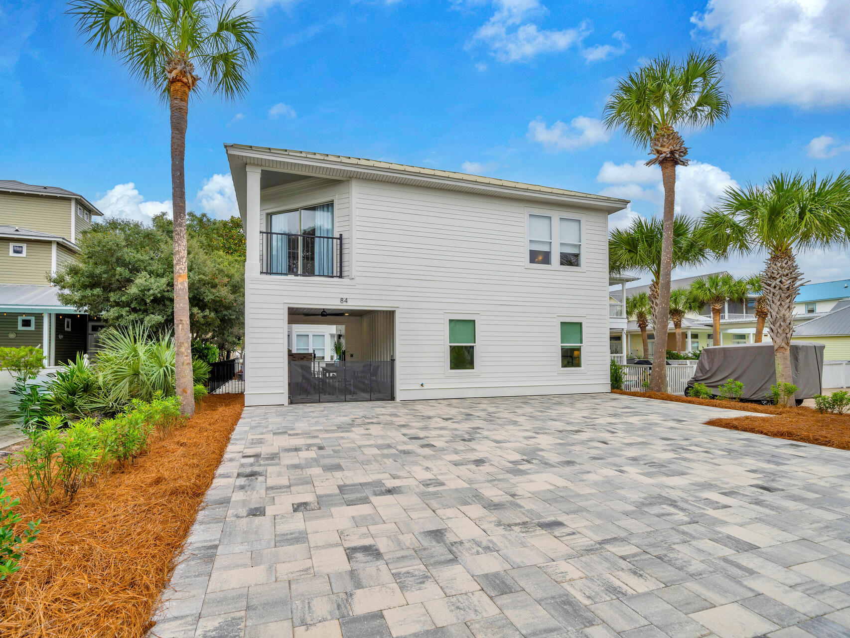 84 Mark Street Destin, FL 32541 - Photo 48 of 81 a front view of a house with a yard and garage