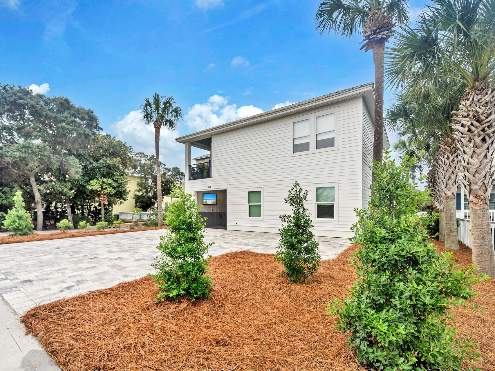 84 Mark Street Destin, FL 32541 - Photo 50 of 81 a front view of a house with garden