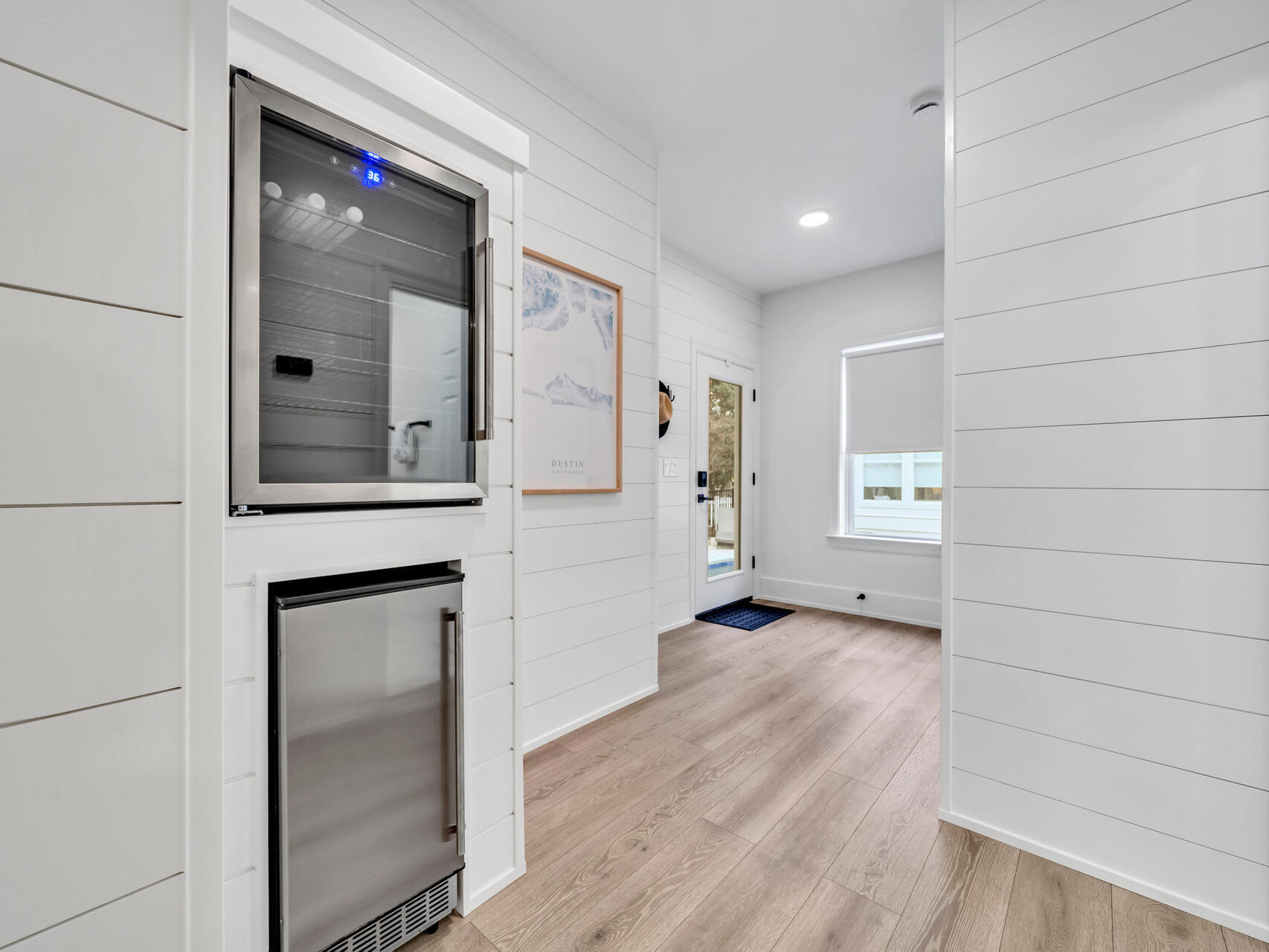 84 Mark Street Destin, FL 32541 - Photo 58 of 81 a view of a hallway with wooden floor and a cabinet