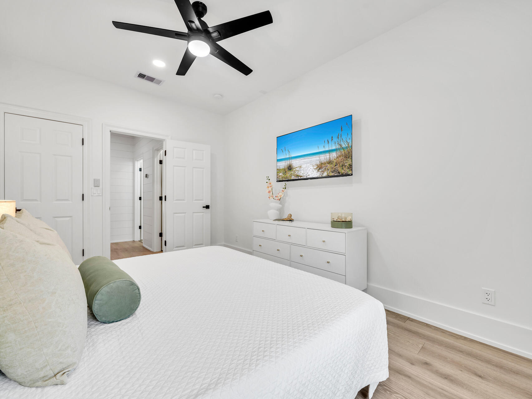 84 Mark Street Destin, FL 32541 - Photo 60 of 81 a bedroom with a bed and a painting on the wall