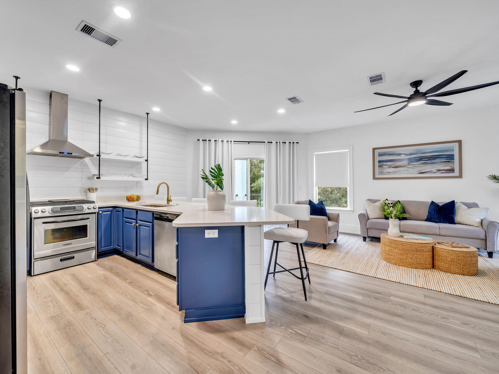 84 Mark Street Destin, FL 32541 - Photo 67 of 81 a kitchen with stainless steel appliances granite countertop a stove top oven a refrigerator a dining table and chairs with wooden floor