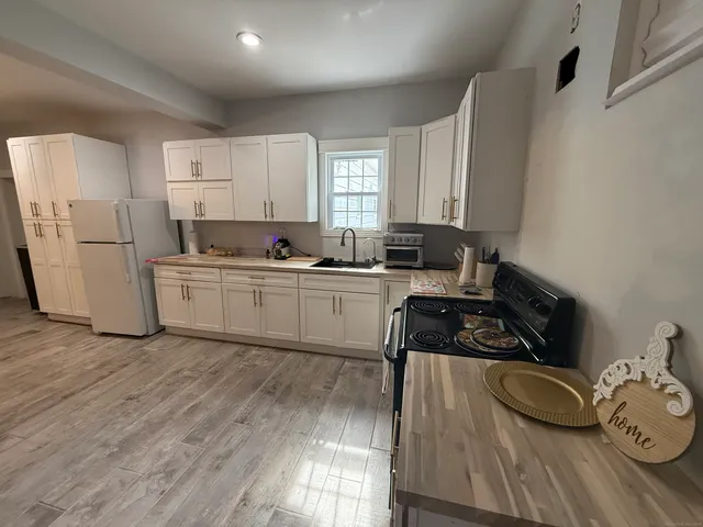 a kitchen with a sink a stove and cabinets