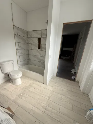 an empty room with floor to ceiling window and fireplace