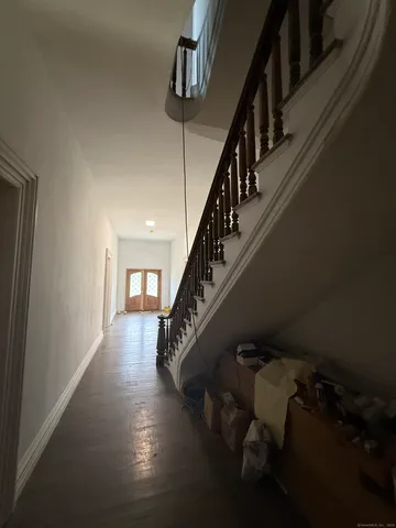 a view of entryway and hall with wooden floor
