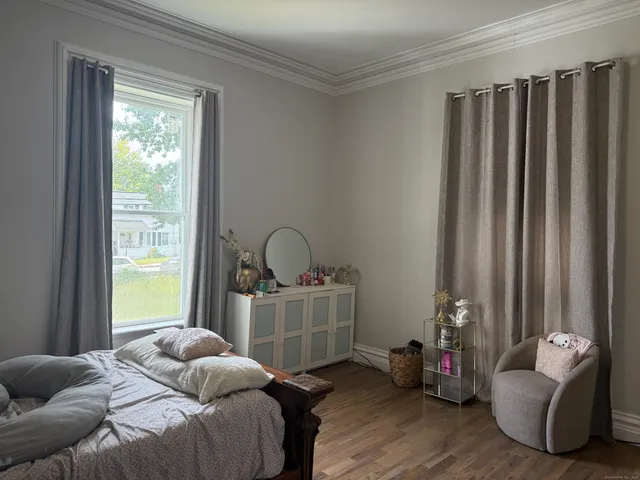 a bedroom with bed and a window
