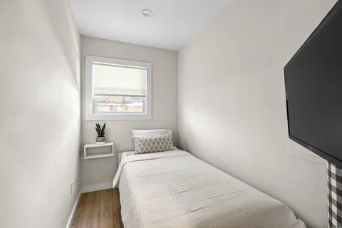 a bedroom with a bed and window