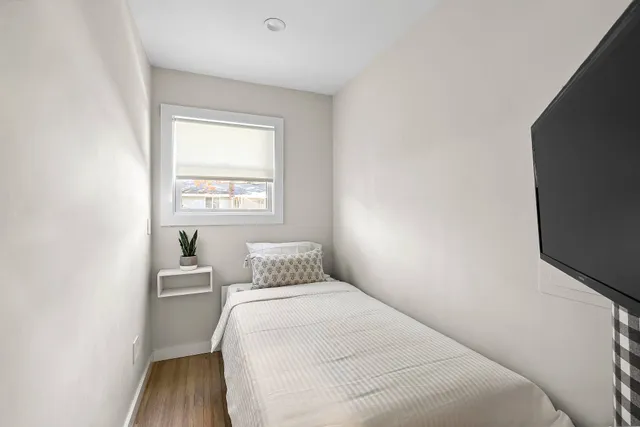 a bedroom with a bed and window