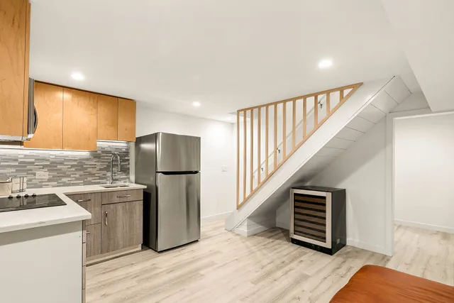 a kitchen with stainless steel appliances granite countertop a refrigerator and a stove top oven
