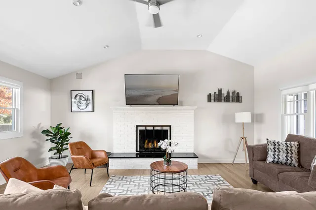 a living room with furniture and a fireplace