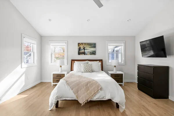 a bedroom with a bed and a flat screen television