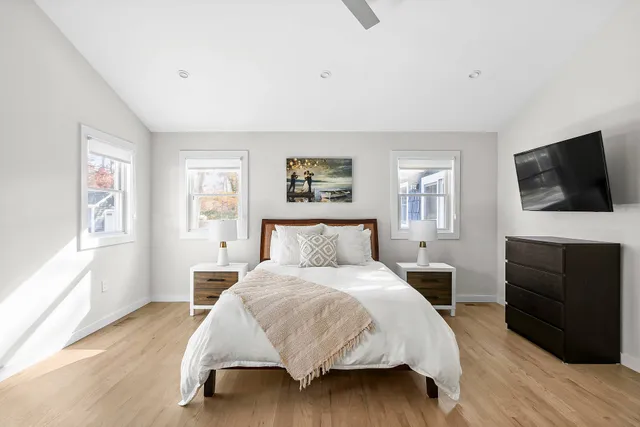 a bedroom with a bed and a flat screen television