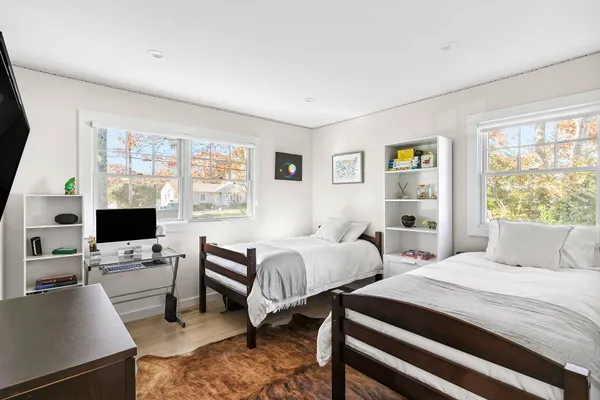 a bedroom with two beds and a window