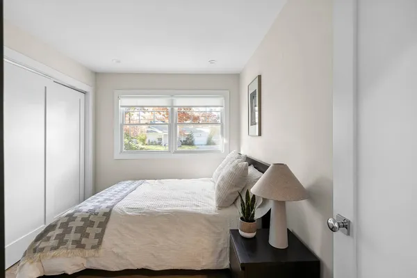 a bedroom with a bed and a window