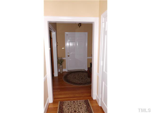 101 Forest Road Oxford, NC 27565 - Photo 17 of 25 Back up stairs, this shows the Foyer and coat closet from the hallway showing the spacious entry area. The beautiful hardwoods continue in this area.