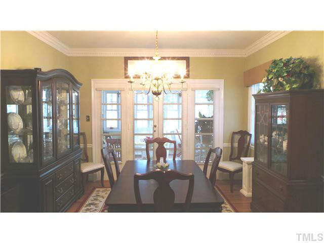 From the opening to the Living Room, this shows the Dining room.  The crown dental molding continues in this room.  The French doors open to a beautiful Sun Room to be shown later.  The Dining Room has hardwood floors and a beautiful chandelier.