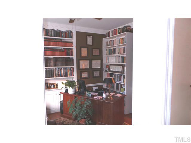 101 Forest Road Oxford, NC 27565 - Photo 8 of 25 Looking from the Foyer, this is the Library/Study. There are ample built-in book cases. Note the hardwood floors as well as the continuing crown dental molding. This room also has a ceiling fan.