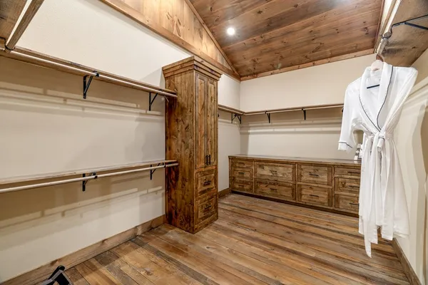 a bathroom with a granite countertop sink a mirror and shower