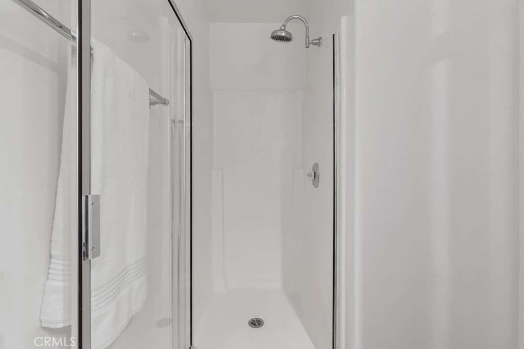 20317 Livorno Porter Ranch Porter Ranch, CA 91326 - Photo 15 of 33 a bathroom with a glass shower door