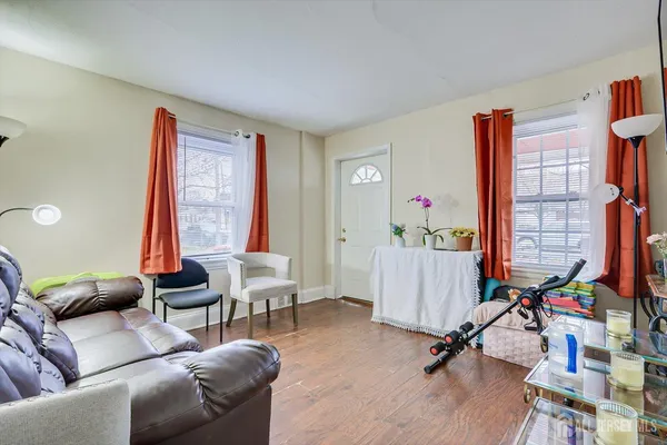 a living room with furniture gym equipment and a large window
