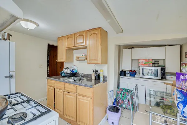 a kitchen with stainless steel appliances a sink stove and cabinets