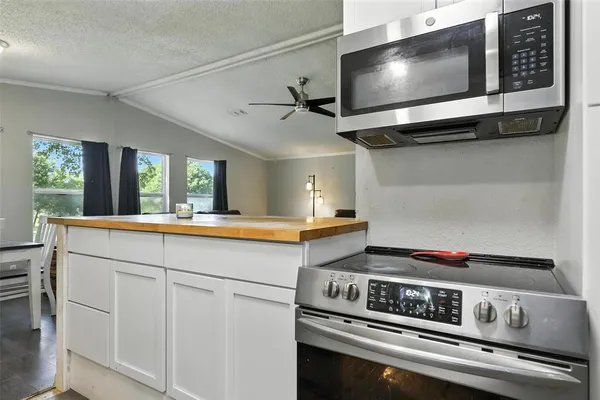 a kitchen with a stove and a microwave