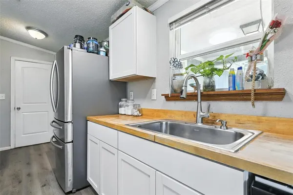 a kitchen with stainless steel appliances granite countertop a sink and a refrigerator