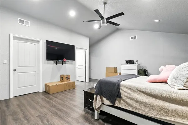 a bedroom with a bed and a flat screen tv