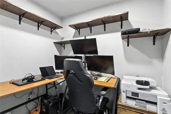 a view of workspace with wooden floor and windows