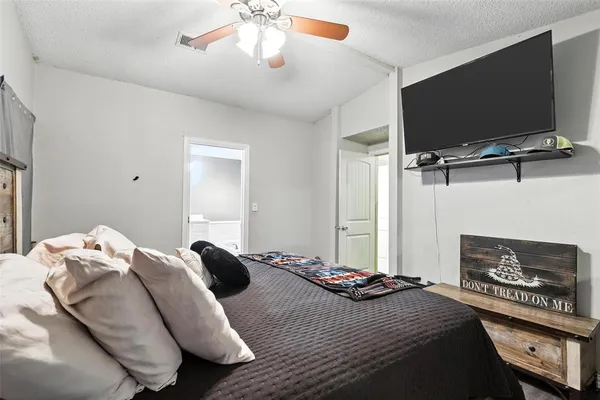 a bedroom with a bed and a flat screen tv