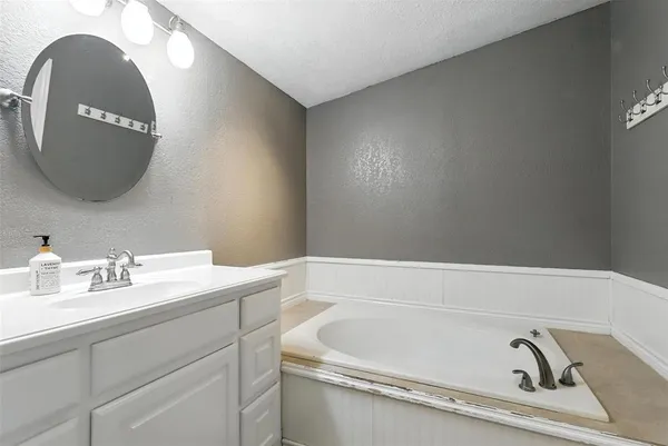 a bathroom with a bathtub and a sink