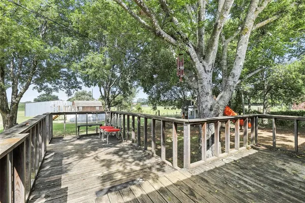 a view of balcony with wooden floor and fence