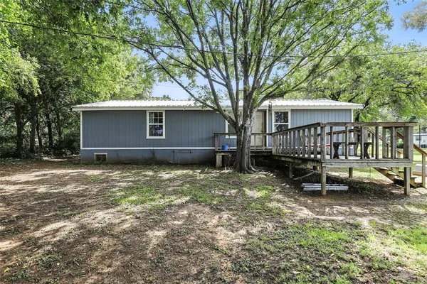 a view of backyard with a garden and deck