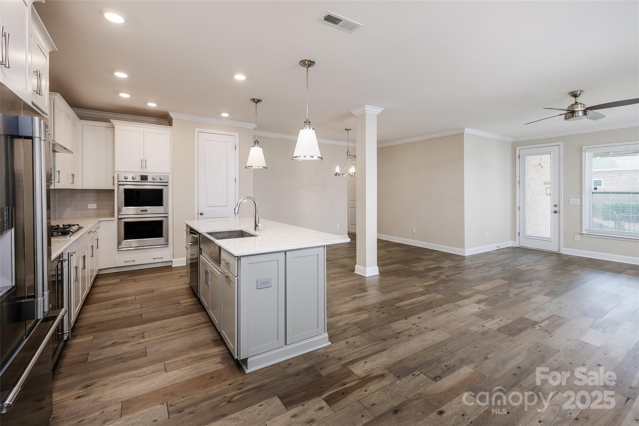 707 Marion Drive Matthews, NC 28105 - Photo 4 of 30 a kitchen with a sink stainless steel appliances cabinets and a counter top space