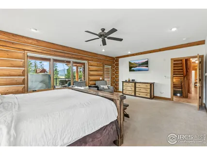 a spacious bedroom with a large bed and a chandelier