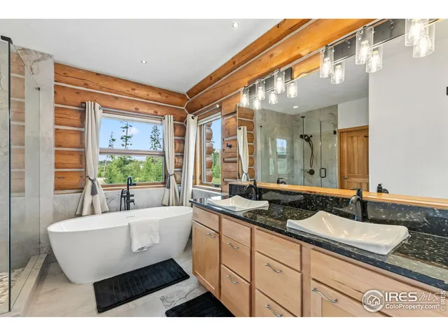 a spacious bathroom with a granite countertop sink and a large mirror